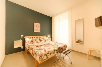 a bedroom with a bed and a mirror in it at Domus Paruta in Rome