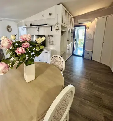 a dining room table with a vase of flowers on it at La casa di Roby in Rome