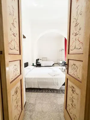 a bedroom with a white bed in a room at Sant'Onofrio Boutique Apartment in Rome