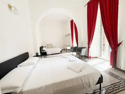 a bedroom with a large bed with red curtains at Sant'Onofrio Boutique Apartment in Rome
