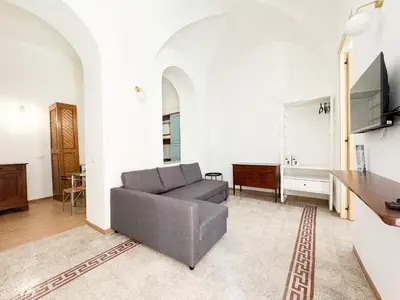 a living room with a couch and a tv at Sant'Onofrio Boutique Apartment in Rome