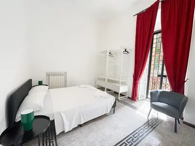 a bedroom with a bed and a table and a chair at Sant'Onofrio Boutique Apartment in Rome