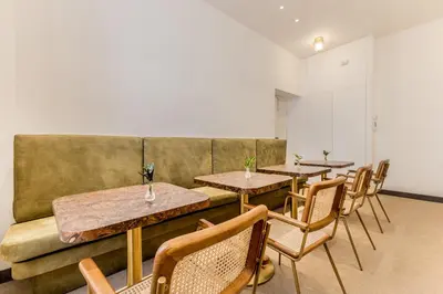a restaurant with tables and chairs and a couch at Sophia B&B 94 Trastevere in Rome