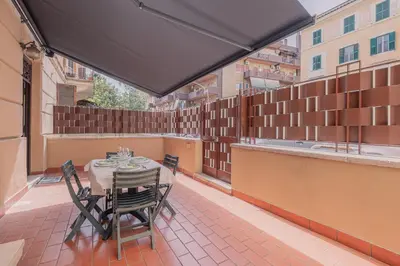 a patio with a table and chairs on a balcony at Furi Loft Garden in Rome