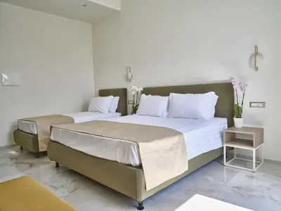 two beds in a room with white walls at King Vittorio Guest House in Rome
