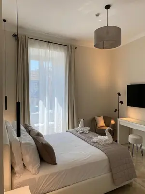 a bedroom with a bed and a large window at Golden Round Palace in Rome