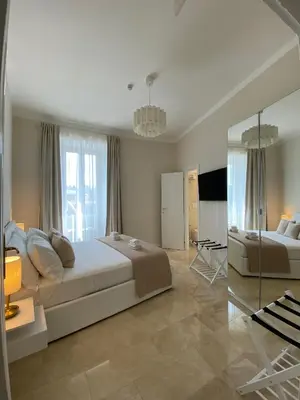 a large bedroom with a large bed and a table at Golden Round Palace in Rome