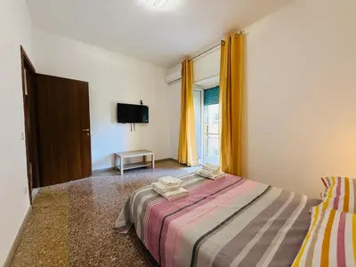 a bedroom with a bed and a television in it at Metro A Battistini - Ramat House in Rome