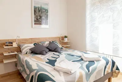 a bedroom with a bed with towels on it at Urban Nest - Trastevere by RHR in Rome
