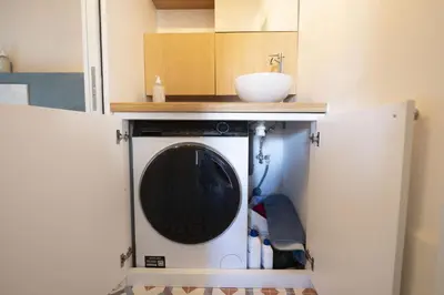 a washing machine in a kitchen with a sink at Roman Dream in Campo de Fiori in Rome