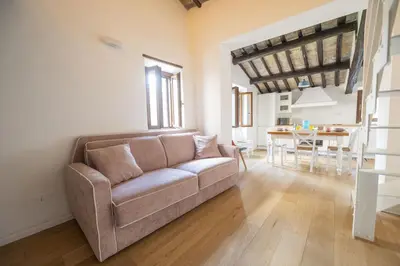 a living room with a couch and a table at Roman Dream in Campo de Fiori in Rome