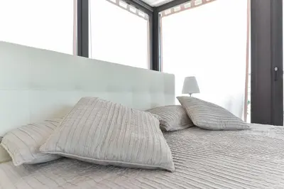a bed with two pillows on it in a bedroom at Vatican Rome Suites in Rome