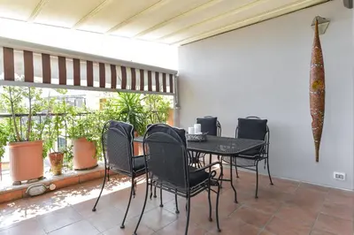 a dining room with a black table and chairs at Vatican Rome Suites in Rome