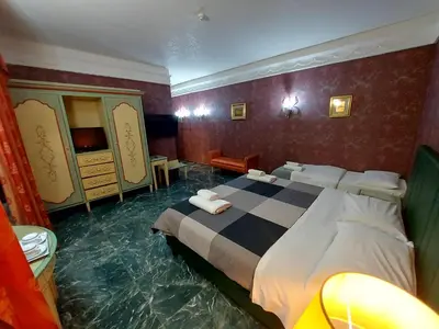 a hotel room with a bed in the middle of a flooded room at Alloggio Positano in Rome