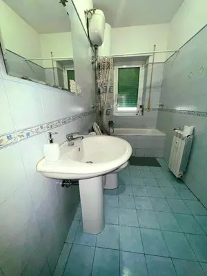 a bathroom with a sink and a mirror and a tub at Montitiburtini Appartamento 510 Roma Centro in Rome