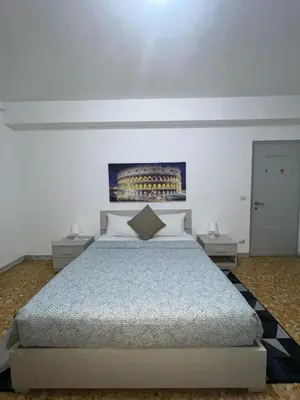 a bedroom with a bed and two night stands at Montitiburtini Appartamento 510 Roma Centro in Rome