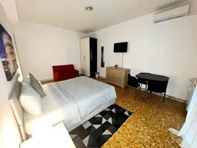 a bedroom with a bed and a table and a desk at Montitiburtini Appartamento 510 Roma Centro in Rome