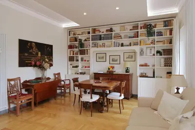 a living room with a table and a desk at Flaminio Arte & Musica in Rome