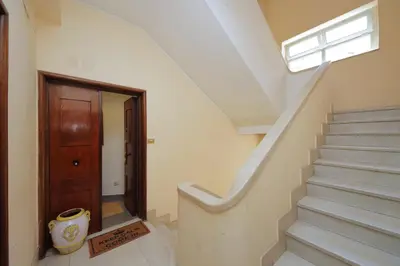 a hallway with stairs and a wooden door at Flaminio Arte & Musica in Rome
