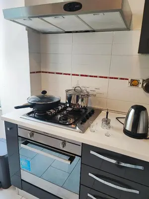 a kitchen with a stove with pots and pans on it at Residenza Giolitti in Rome