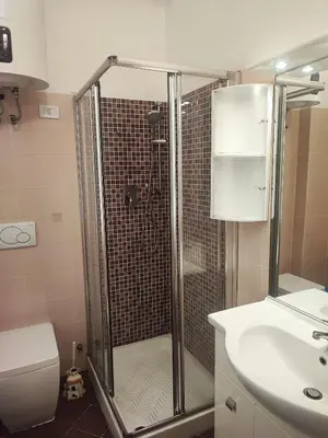 a bathroom with a shower and a toilet and a sink at Residenza Giolitti in Rome