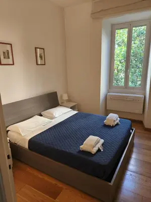a bedroom with a bed with two towels on it at Suite Tevere star in Rome