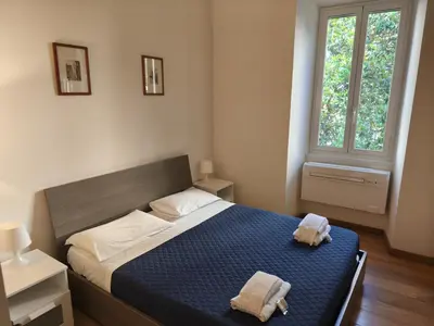 a bedroom with a bed with two towels on it at Suite Tevere star in Rome