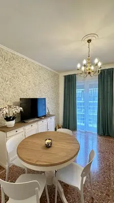 a dining room with a table and chairs and a television at Vatican Museum YH in Rome