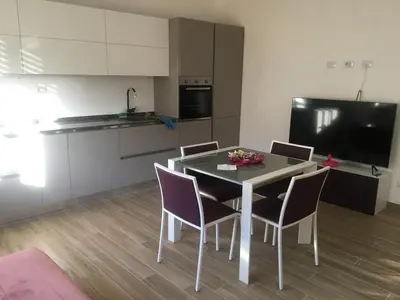 a kitchen with a table and chairs in a room at Francy's home sweet home in Rome