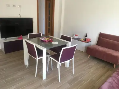 a living room with a table and chairs and a couch at Francy's home sweet home in Rome