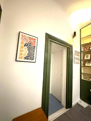 a hallway with a door and a picture on the wall at Caserina Lux Roma in Rome