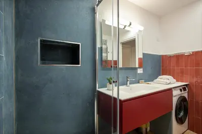 a bathroom with a sink and a washing machine at Margherita Flat in Rome