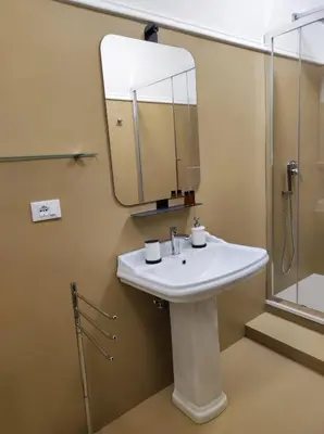 a bathroom with a sink and a mirror at Appartamento Lavatore in Rome