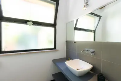 a bathroom with a sink and a window at Loft Ostiense Green in Rome