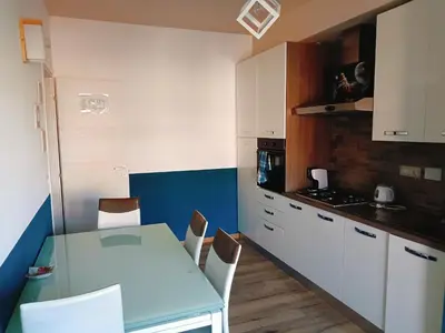 a kitchen with a table and chairs in a room at White Sun in Rome