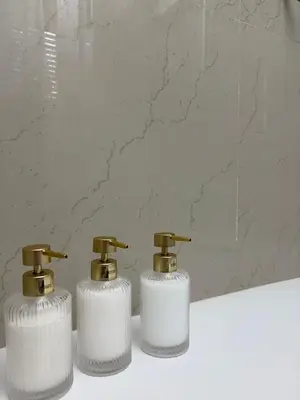 two soap dispensers sitting on top of a bathroom sink at La Canfora in Rome