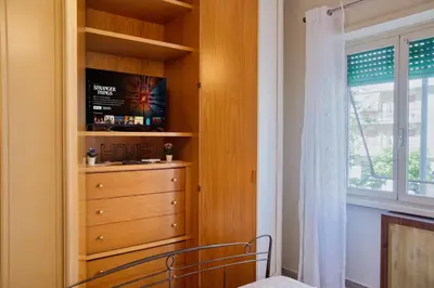 a bedroom with a dresser and a window at Pigneto84 in Rome