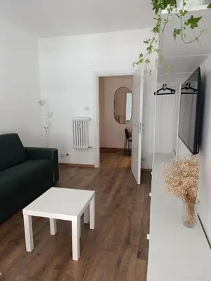 a living room with a black couch and a table at Rome Tiburtina Terrace Inn - casa vacanze in Rome
