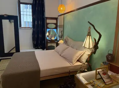 a bedroom with a large bed and a lamp at Midorigami Jacuzzi suite Spanish Steps apt in Rome