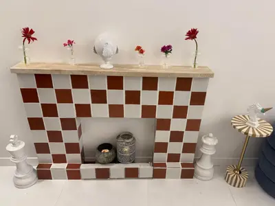a doll house with a checkered fireplace with flowers at Midorigami Jacuzzi suite Spanish Steps apt in Rome