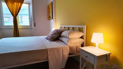 a bedroom with a bed with a lamp and a window at Vatican St Peter Apartment in Rome