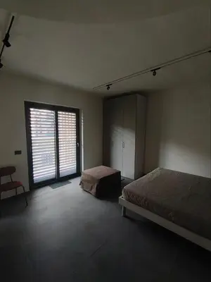 a bedroom with two beds and a large window at Romanello case e appartamenti vacanza in Rome