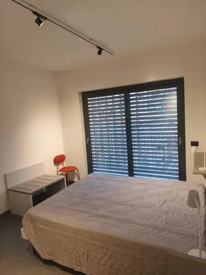 a bedroom with a bed and a desk and a window at Romanello case e appartamenti vacanza in Rome