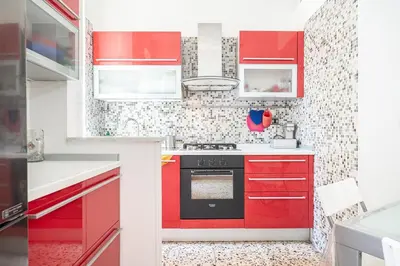 a red kitchen with red cabinets and a stove at Rome Sweet Home I Elegance and Authenticity in Rome