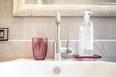 a bathroom with a sink and a mirror at Rome Sweet Home I Elegance and Authenticity in Rome