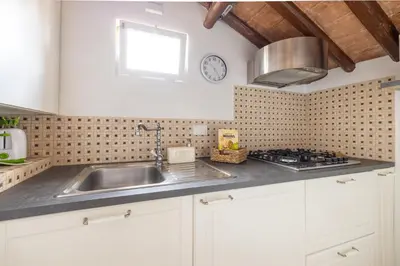 a kitchen with a sink and a clock on the wall at Attico con terrazza privata silenzioso casa Mem in Rome