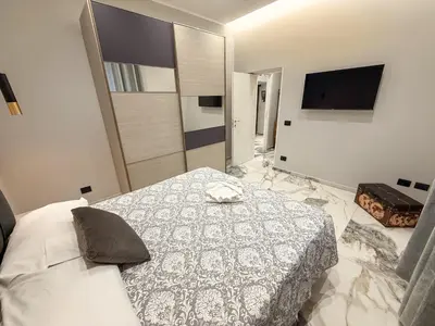 a bedroom with a bed and a television on the wall at Feffo's home - Casa per 4 persone in Rome