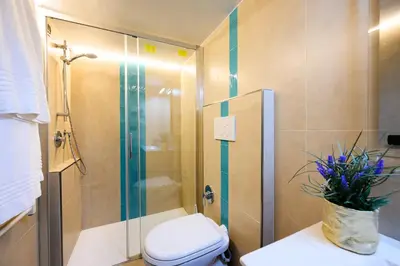 a bathroom with a toilet and a glass shower at Gracchi Vatican View in Rome