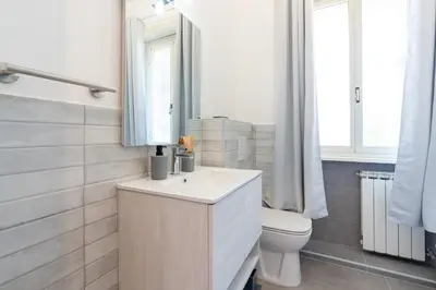 a bathroom with a sink and a toilet and a mirror at Guest House Rome - Pigneto in Rome