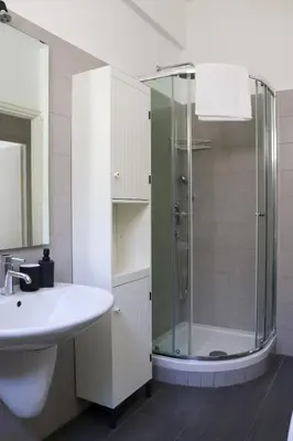a bathroom with a sink and a shower at Dimora Trasteverina Holiday Home in Rome
